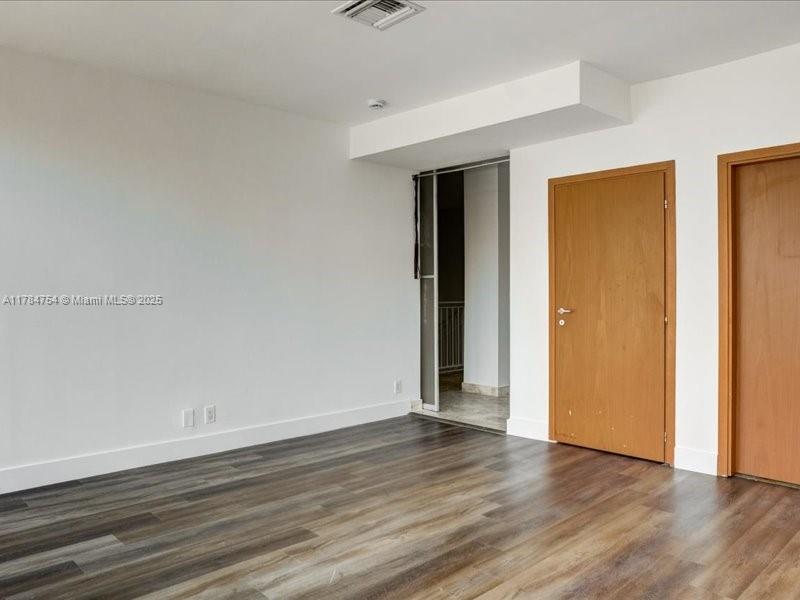 9499 Collins Avenue, Unit PH03 Surfside, FL 33154 - Photo 29 of 82 a view of an empty room with wooden floor