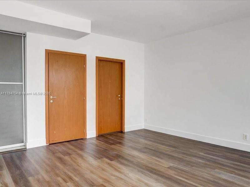 9499 Collins Avenue, Unit PH03 Surfside, FL 33154 - Photo 30 of 82 a view of an empty room with wooden floor and closet