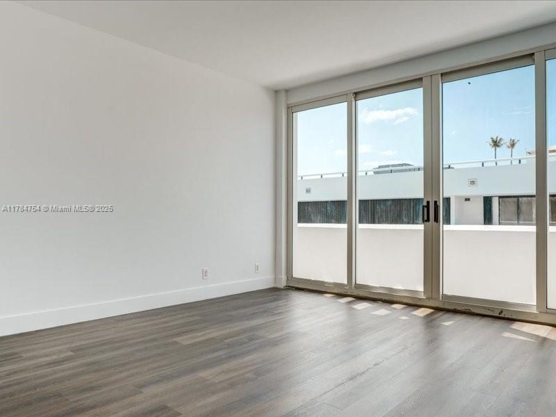 9499 Collins Avenue, Unit PH03 Surfside, FL 33154 - Photo 33 of 82 an empty room with wooden floor and windows