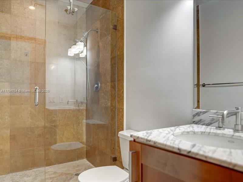 9499 Collins Avenue, Unit PH03 Surfside, FL 33154 - Photo 37 of 82 a bathroom with a granite countertop sink toilet and shower