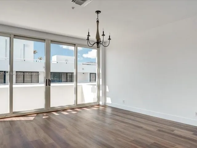 a living room with furniture a flat screen tv and a large window