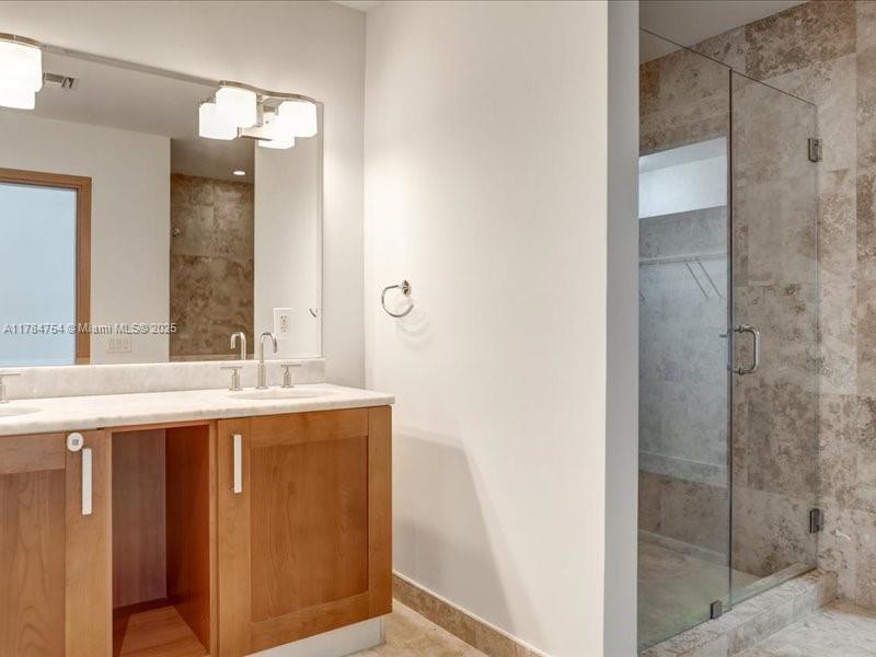 9499 Collins Avenue, Unit PH03 Surfside, FL 33154 - Photo 42 of 82 a bathroom with a granite countertop sink and mirror