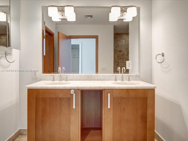 9499 Collins Avenue, Unit PH03 Surfside, FL 33154 - Photo 43 of 82 a bathroom with a granite countertop sink and a mirror
