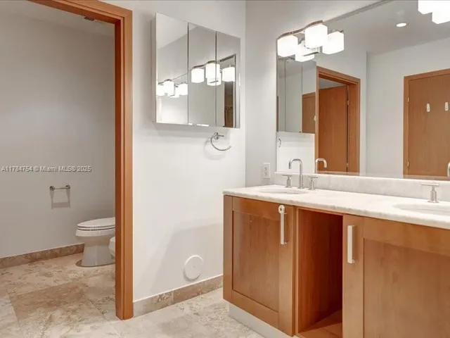 a balcony view with a potted plant and outdoor seating