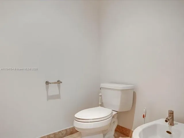 a view of a big yard with potted plants and large trees