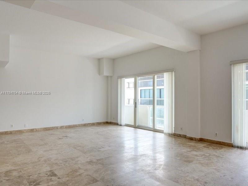 9499 Collins Avenue, Unit PH03 Surfside, FL 33154 - Photo 7 of 82 an empty room with wooden floor and windows