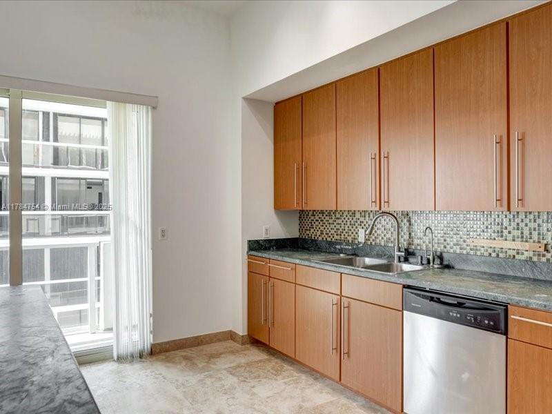 9499 Collins Avenue, Unit PH03 Surfside, FL 33154 - Photo 9 of 82 a kitchen with granite countertop stainless steel appliances a sink and cabinets