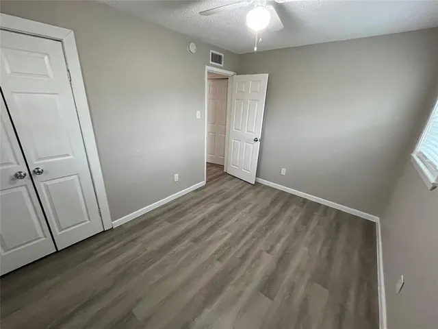 a view of a yard with a house and a large tree