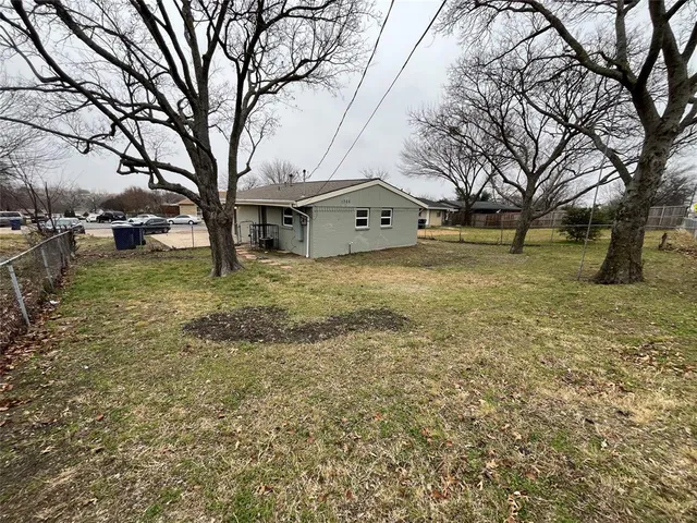a view of a yard with a tree