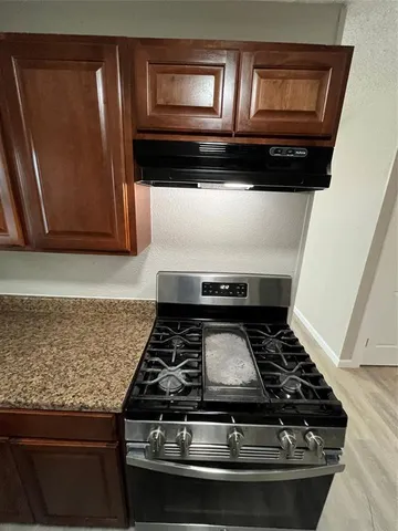 a stove top oven sitting inside of a kitchen