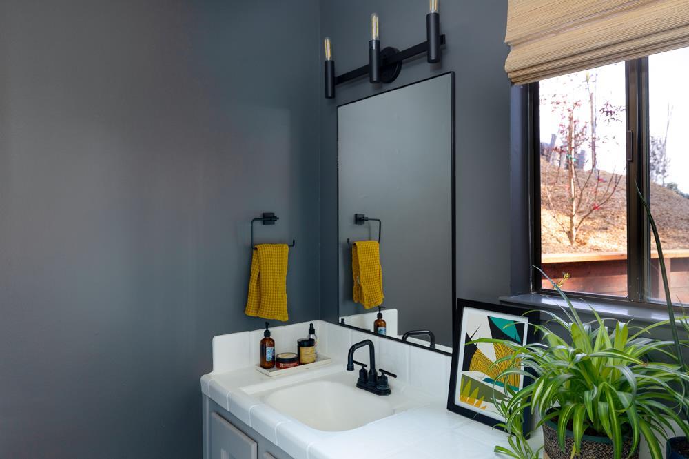 390 Brooktree Ranch Road Aptos, CA 95003 - Photo 11 of 31 a bathroom with a sink mirror and window