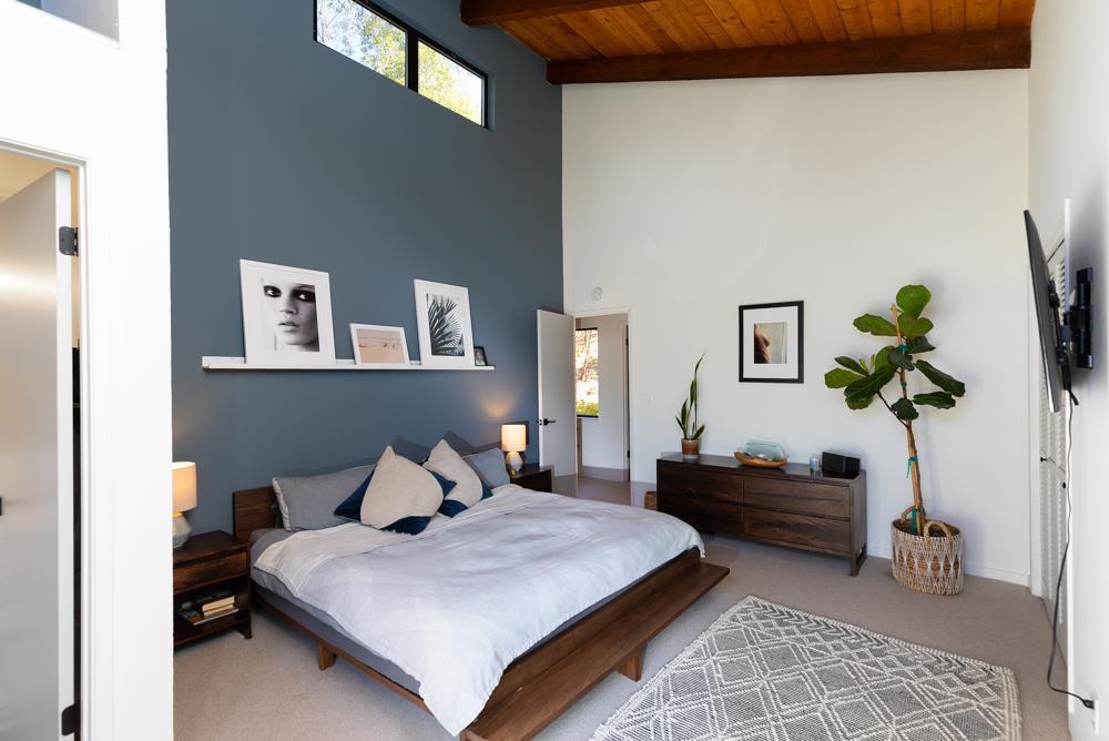 390 Brooktree Ranch Road Aptos, CA 95003 - Photo 18 of 31 a bedroom with a bed potted plant and a window