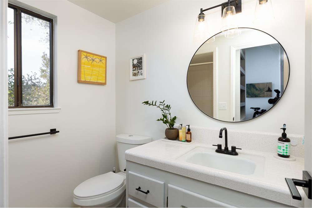 390 Brooktree Ranch Road Aptos, CA 95003 - Photo 19 of 31 a bathroom with a sink a toilet and a mirror