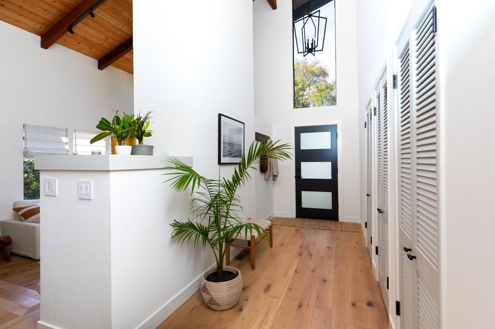 390 Brooktree Ranch Road Aptos, CA 95003 - Photo 2 of 31 a view of a hallway with wooden floor and a potted plant