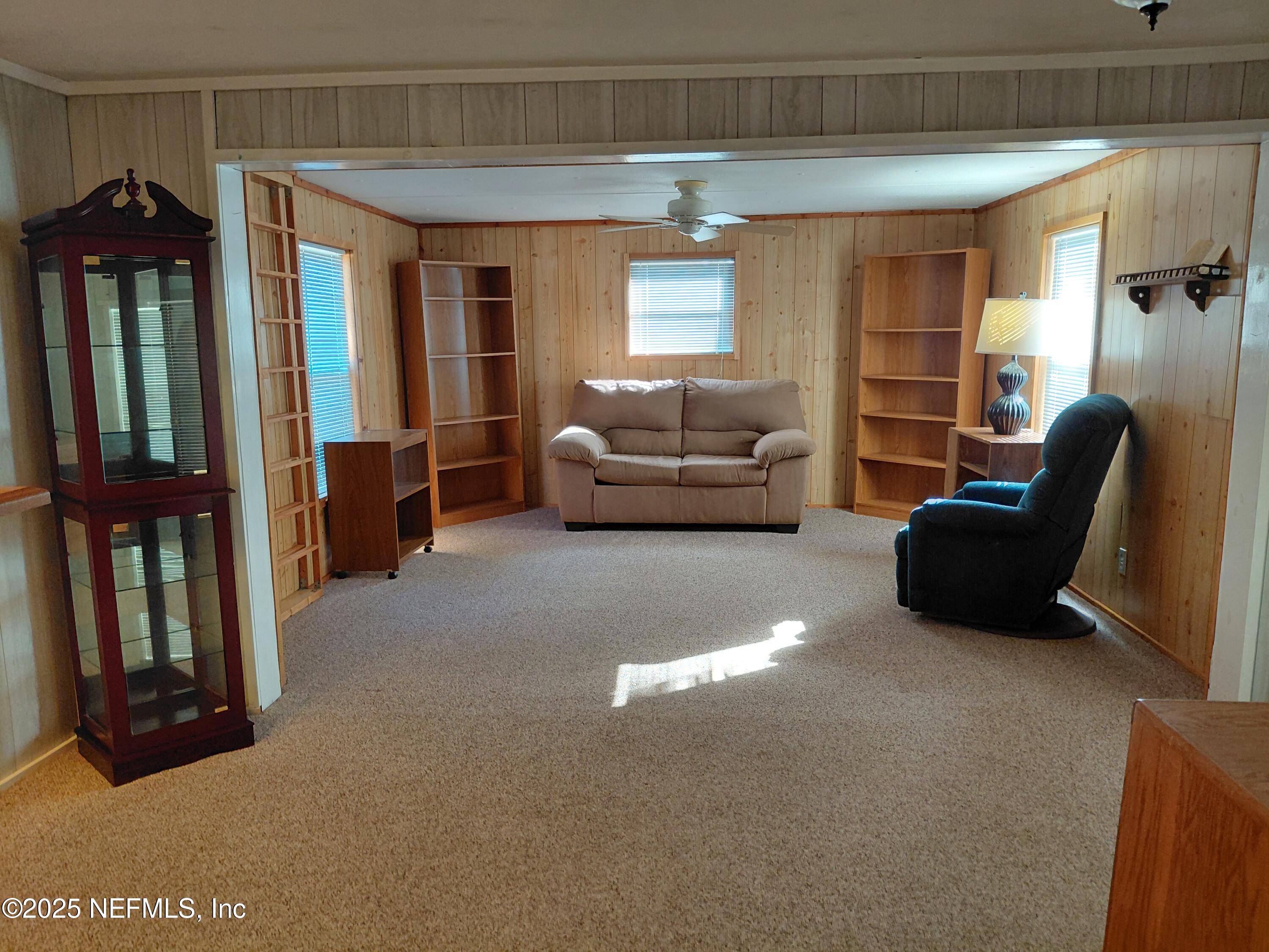 15690 Sears Road Jacksonville, FL 32218 - Photo 12 of 39 a living room with furniture and a window