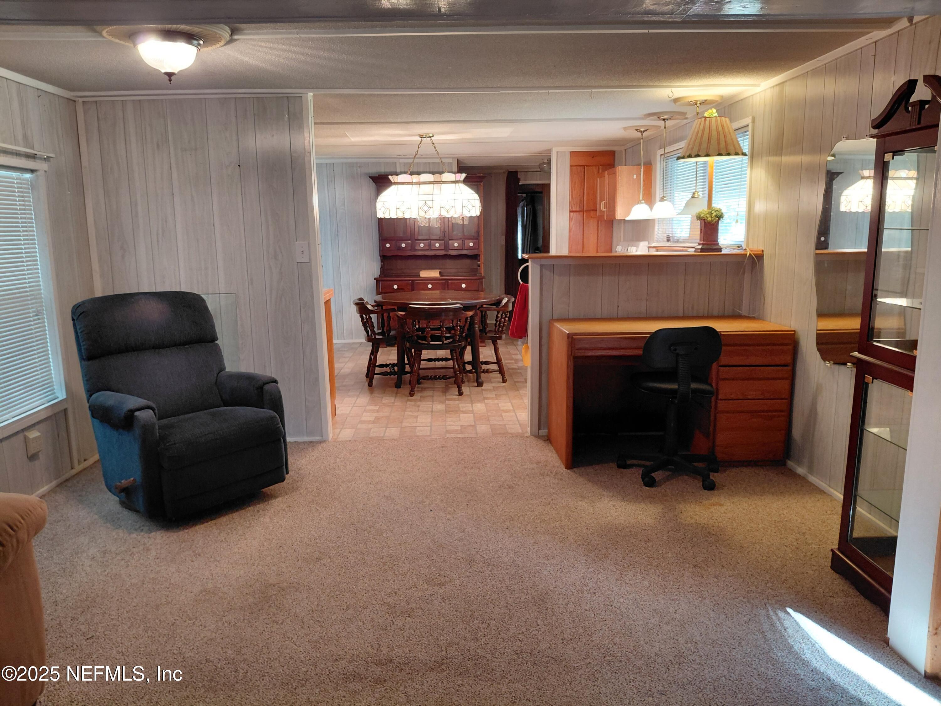15690 Sears Road Jacksonville, FL 32218 - Photo 13 of 39 a living room with furniture a fireplace and a piano