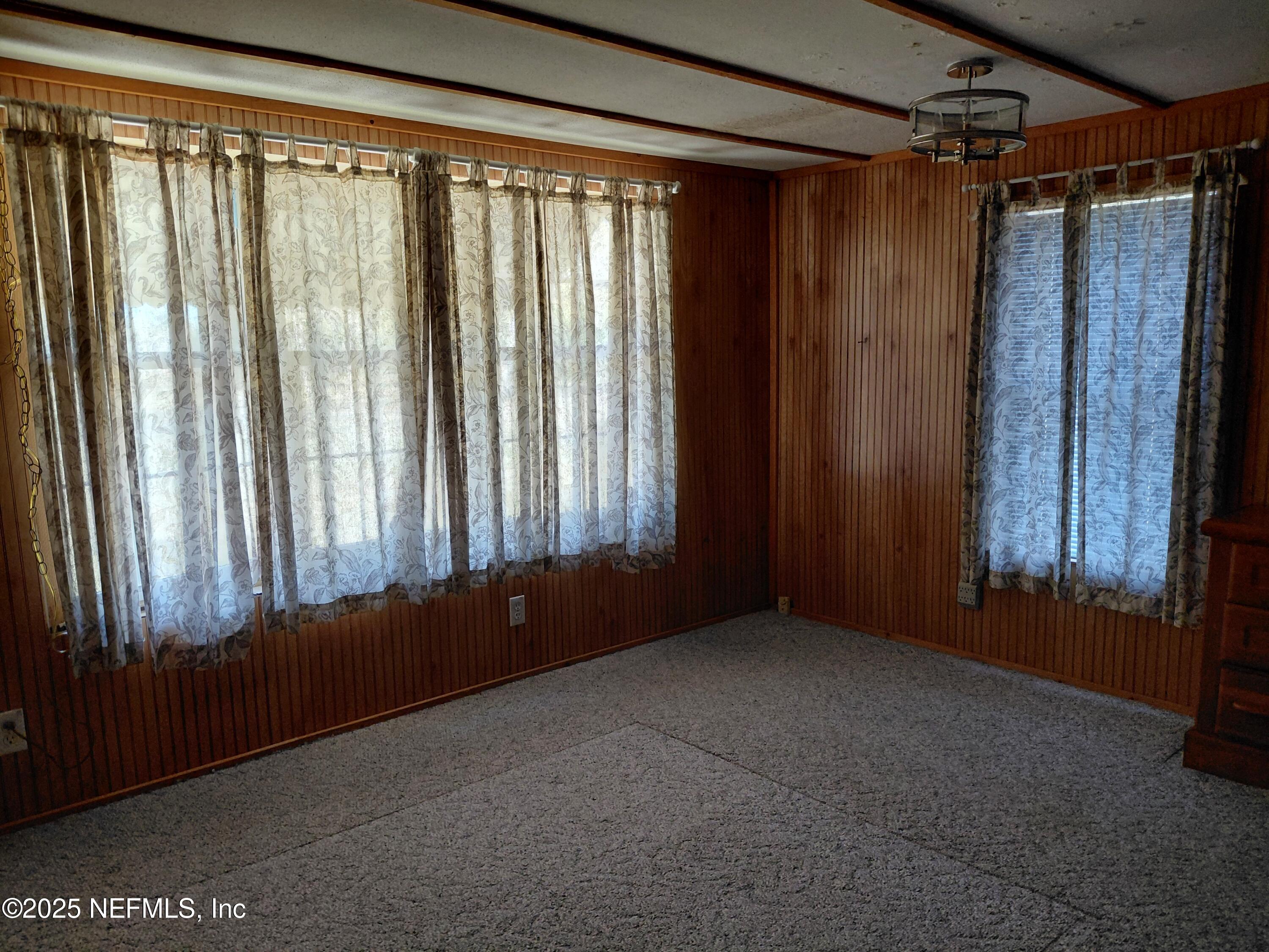 15690 Sears Road Jacksonville, FL 32218 - Photo 16 of 39 a view of an empty room with a window and a balcony