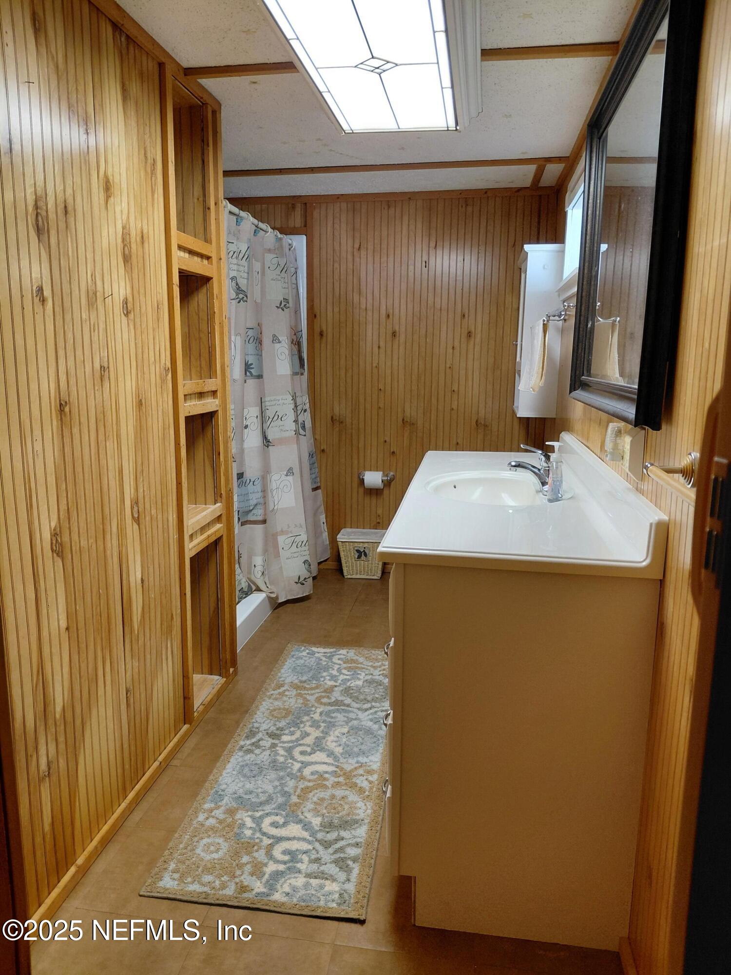 15690 Sears Road Jacksonville, FL 32218 - Photo 17 of 39 a bathroom with a sink and a mirror