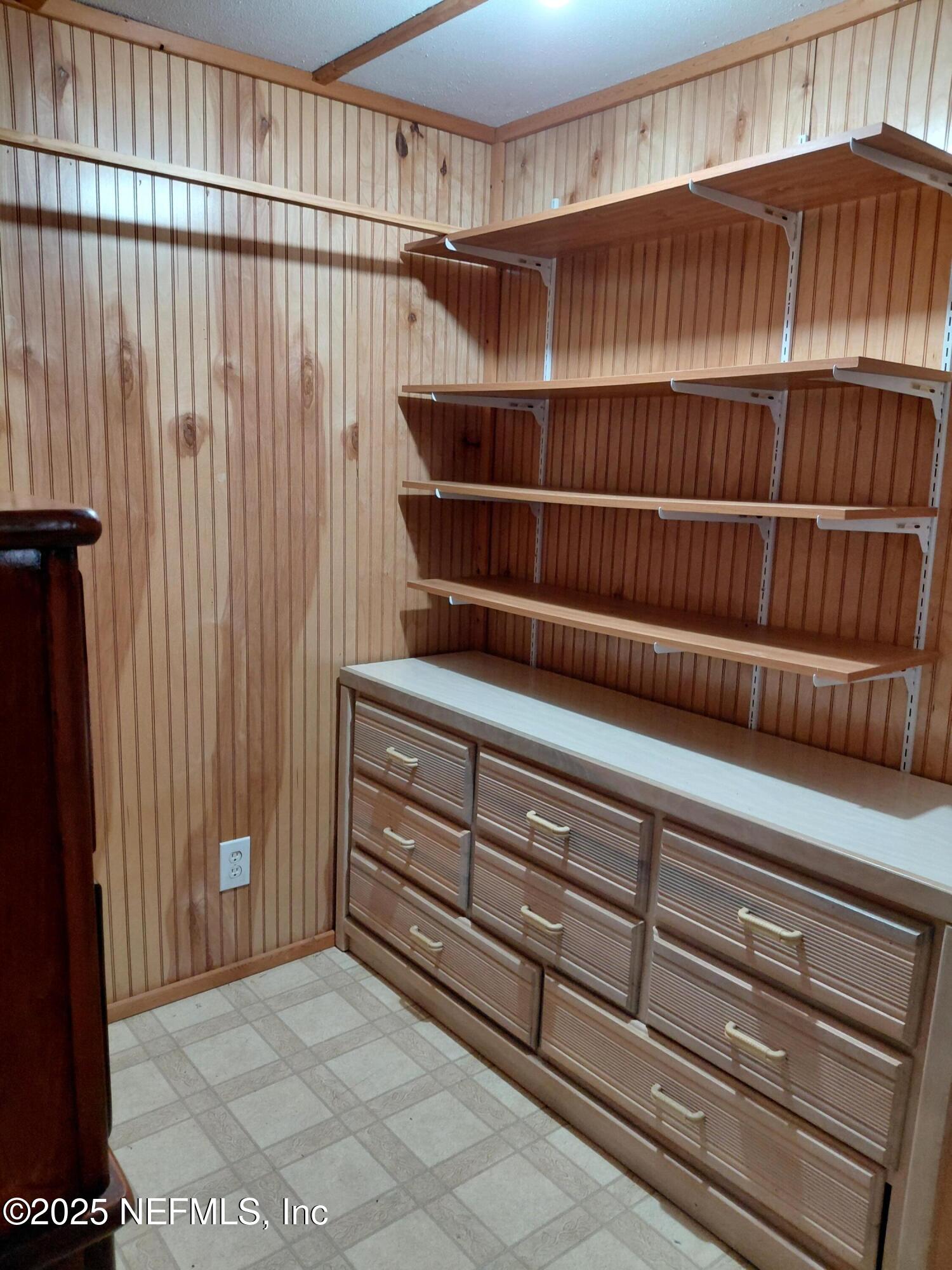 15690 Sears Road Jacksonville, FL 32218 - Photo 20 of 39 a view of walk in closet with empty racks