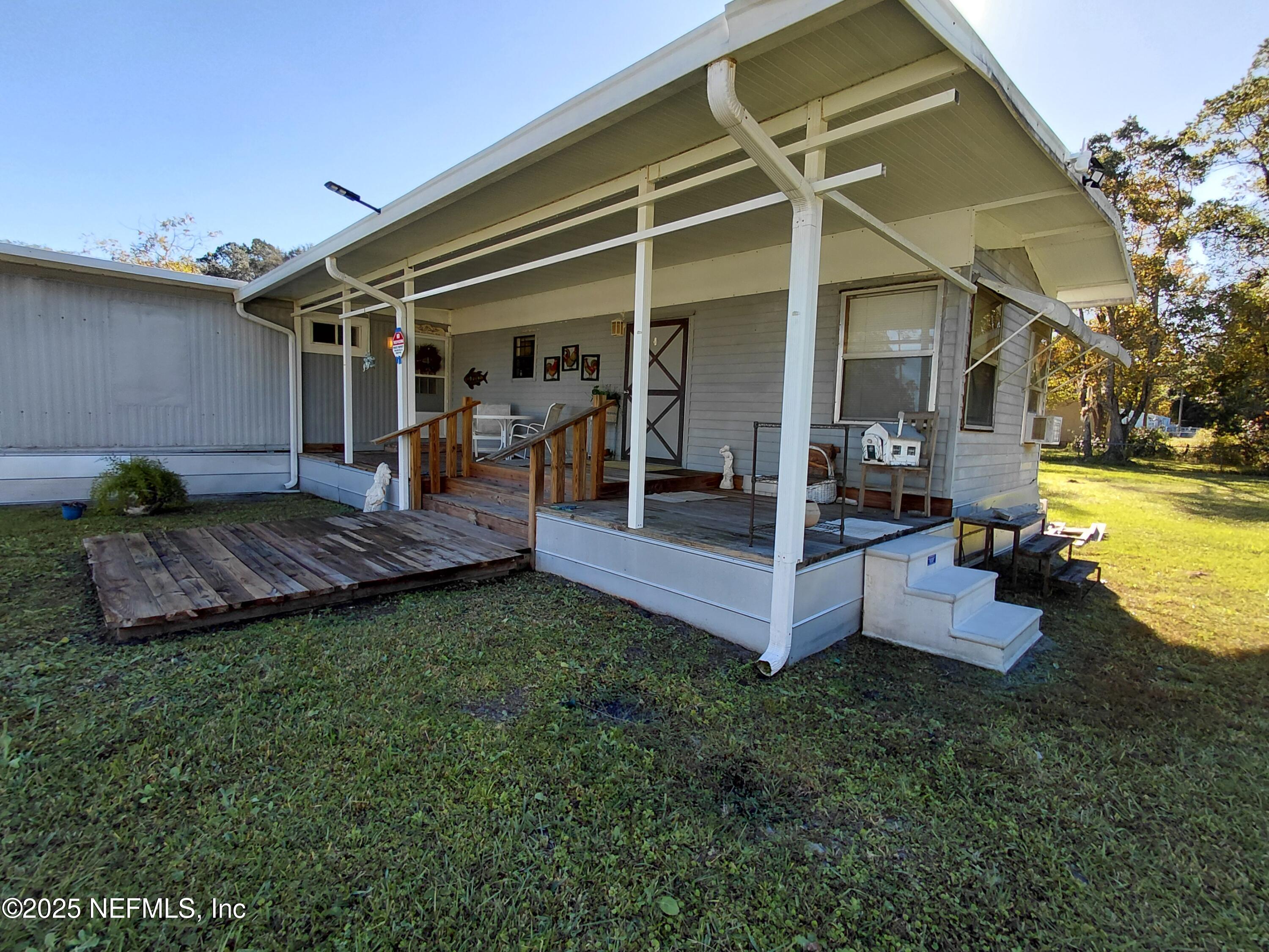 15690 Sears Road Jacksonville, FL 32218 - Photo 25 of 39 a view of a house with backyard porch and sitting area