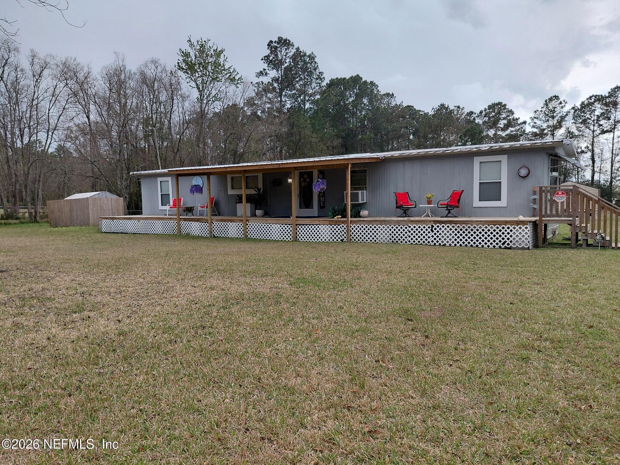 15690 Sears Road Jacksonville, FL 32218 - Photo 3 of 39 a view of a house with a yard and a car