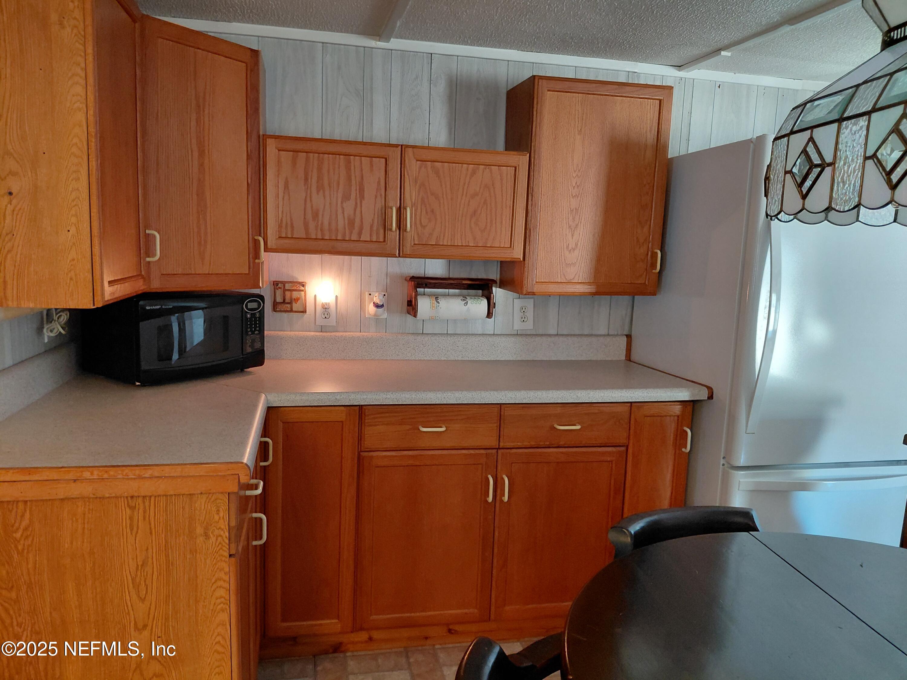 15690 Sears Road Jacksonville, FL 32218 - Photo 9 of 39 a kitchen with stainless steel appliances granite countertop a refrigerator and a stove top oven