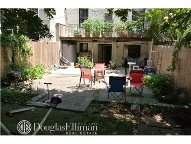 a view of house with backyard and outdoor seating