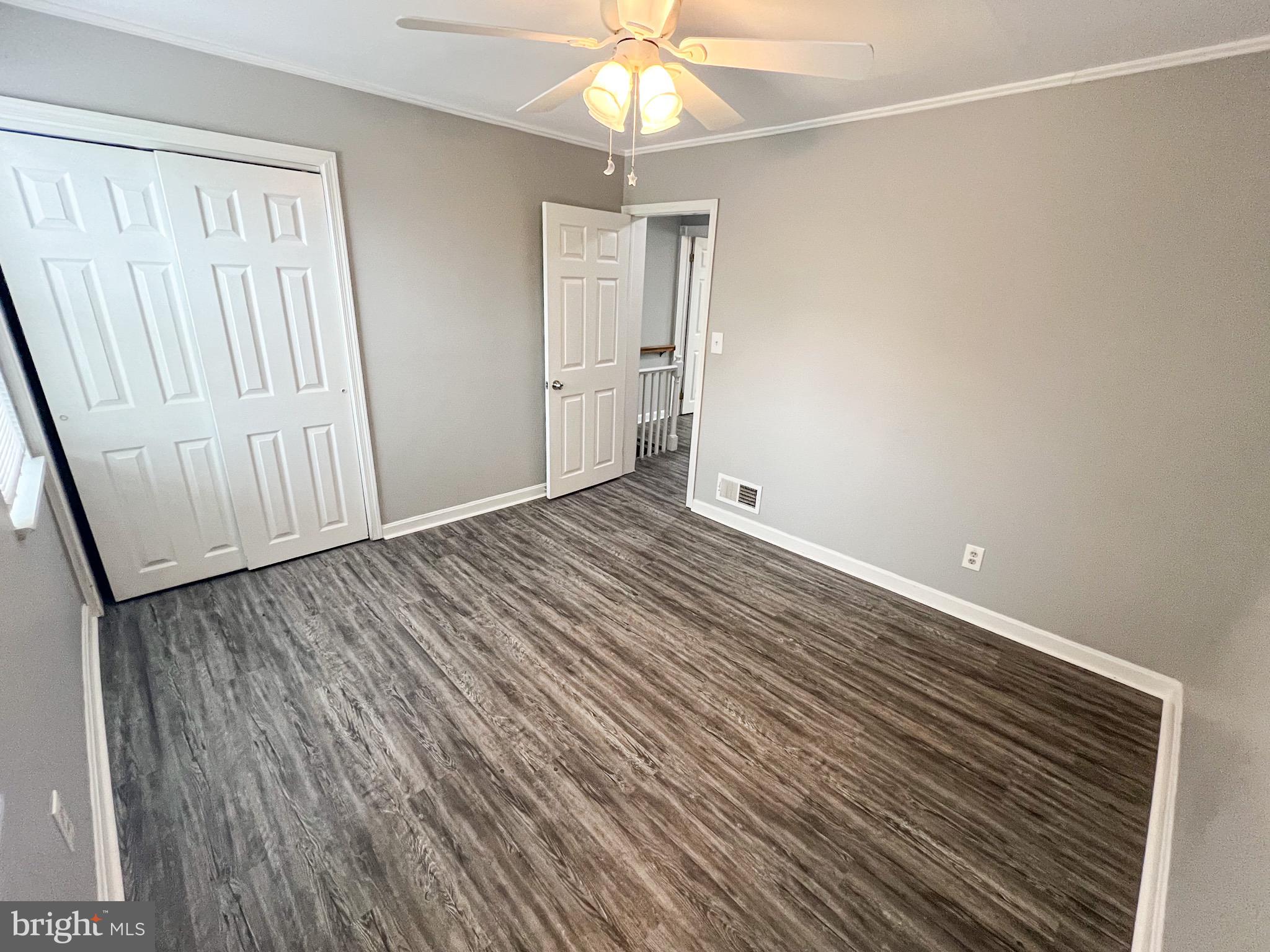 7404 Kirtley Road Baltimore, MD 21222 - Photo 11 of 16 wooden floor in an empty room with a window