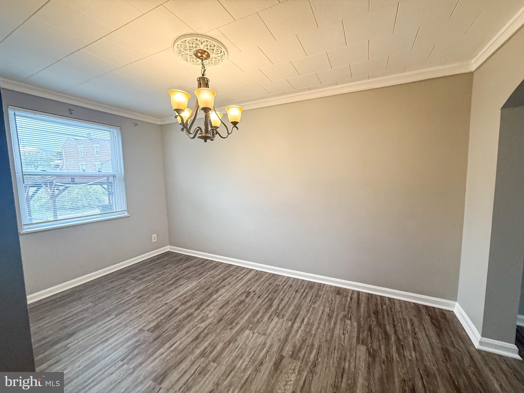 7404 Kirtley Road Baltimore, MD 21222 - Photo 7 of 16 a view of a room with wooden floor closet and chandelier