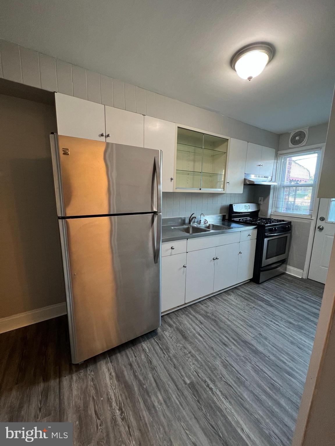 7404 Kirtley Road Baltimore, MD 21222 - Photo 8 of 16 a kitchen with granite countertop a refrigerator a sink dishwasher a stove and a refrigerator