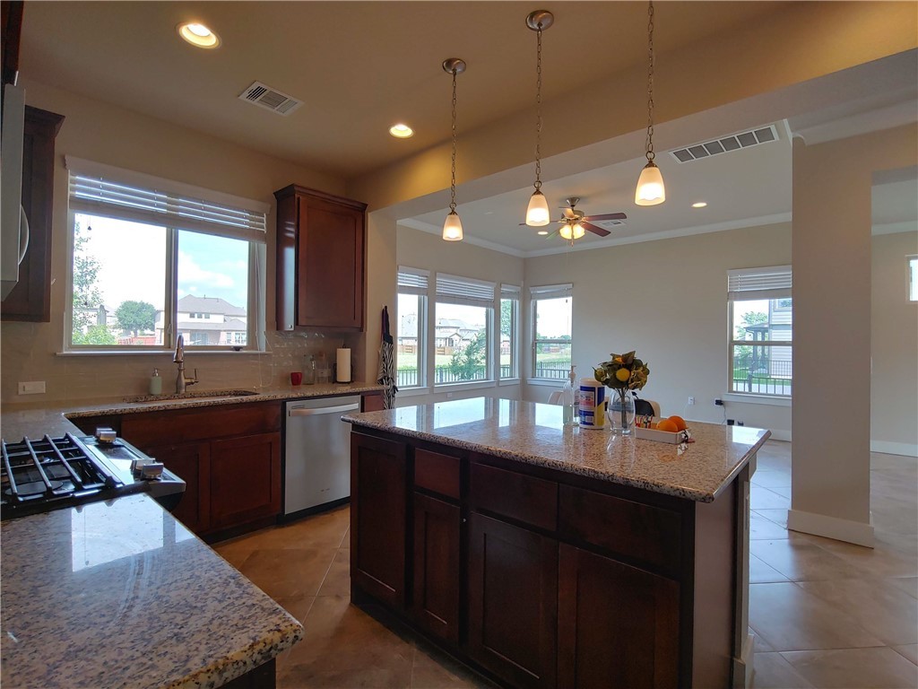 9303 McKnight Loop Austin, TX 78717 - Photo 7 of 18 a kitchen with a sink stove and wooden floor