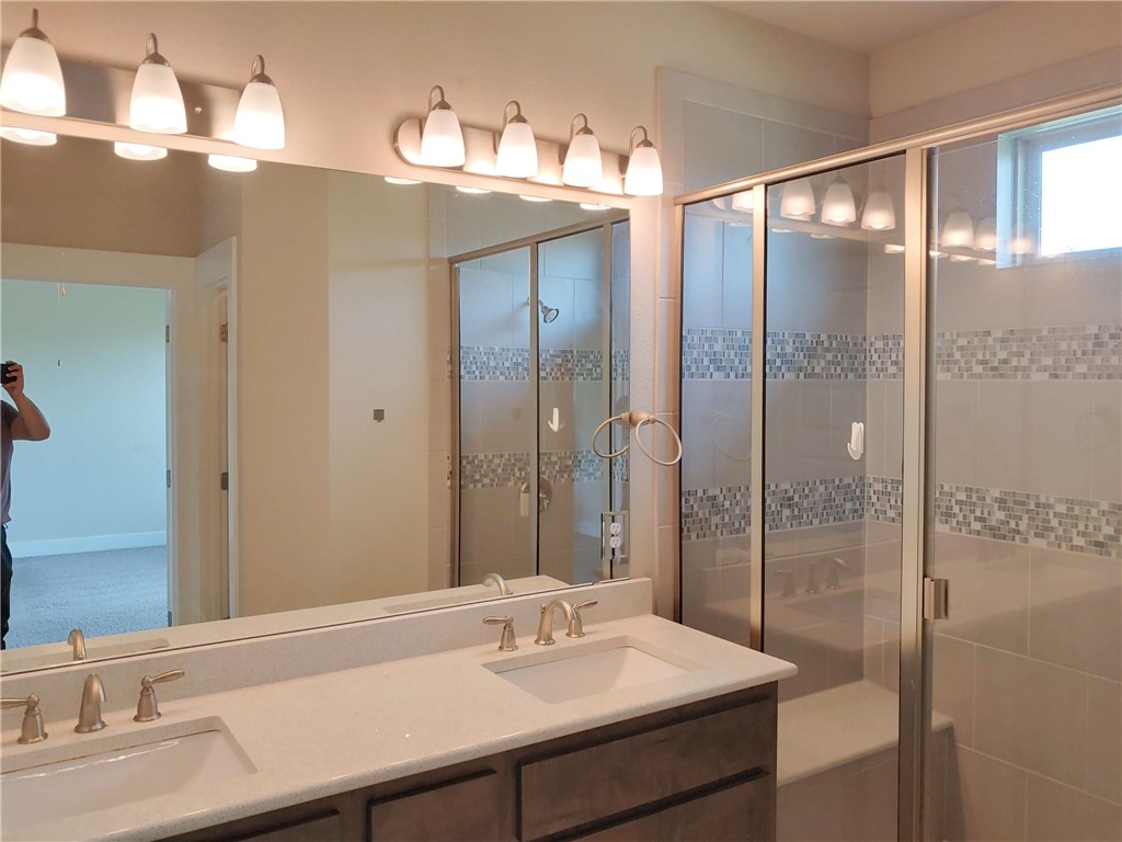9303 McKnight Loop Austin, TX 78717 - Photo 9 of 18 a bathroom with a sink and a mirror