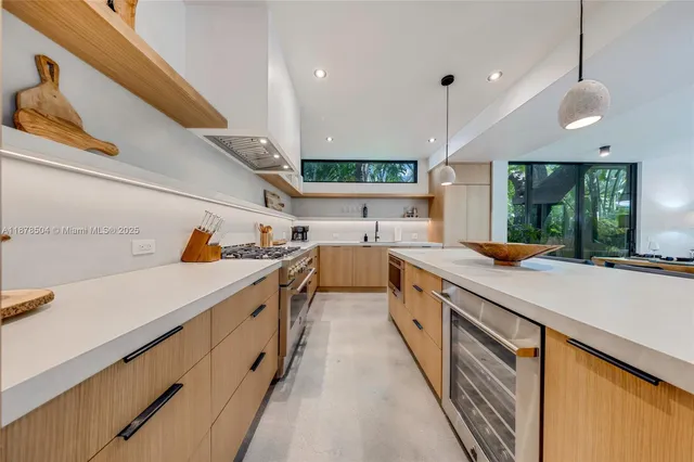 a large kitchen with stainless steel appliances lots of counter space and wooden floor