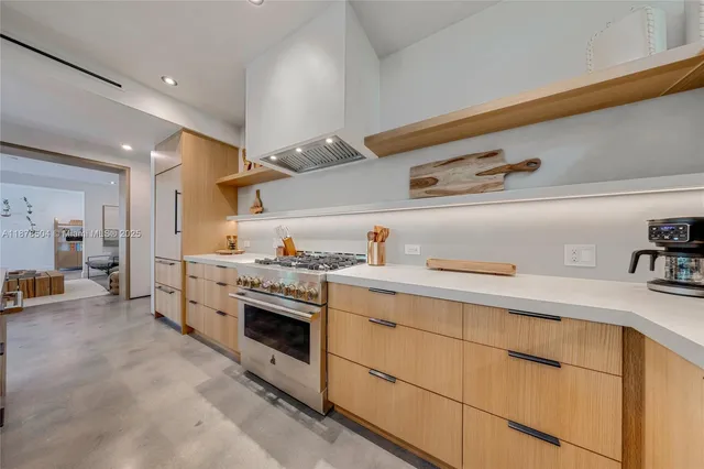 a kitchen with a stove and white cabinets