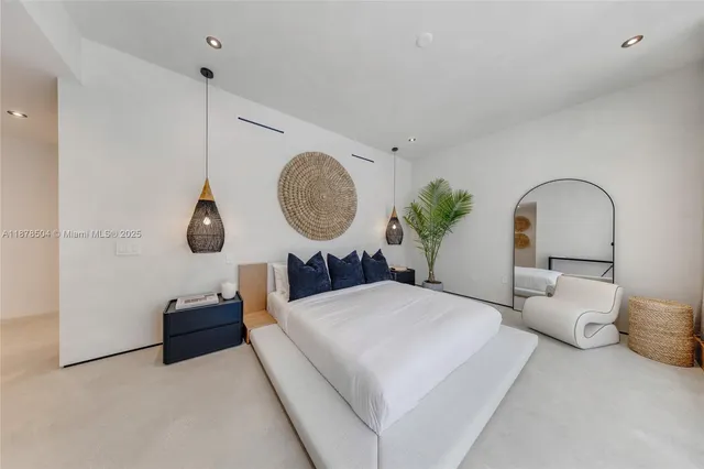 a living room with couches a large mirror and a potted plant