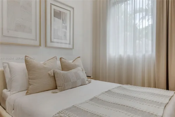 a bed room with a bed and a mirror