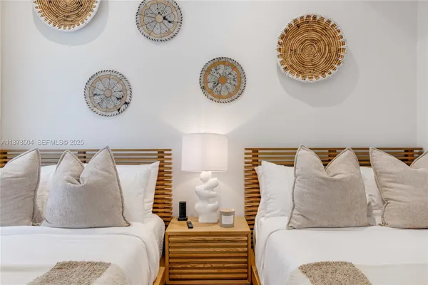 a bedroom with a bed and painting on the wall
