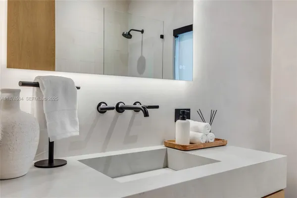 a bathroom with a double vanity sink toilet and mirror