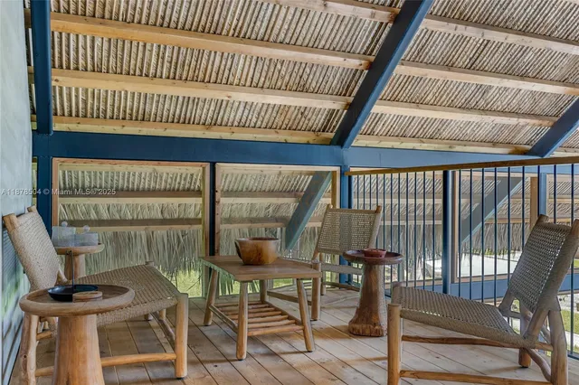 a view of a room with furniture and wooden floor