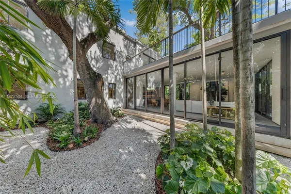 a view of a house with a tree in front