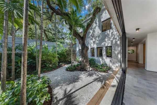 a view of a house with a tree in the background