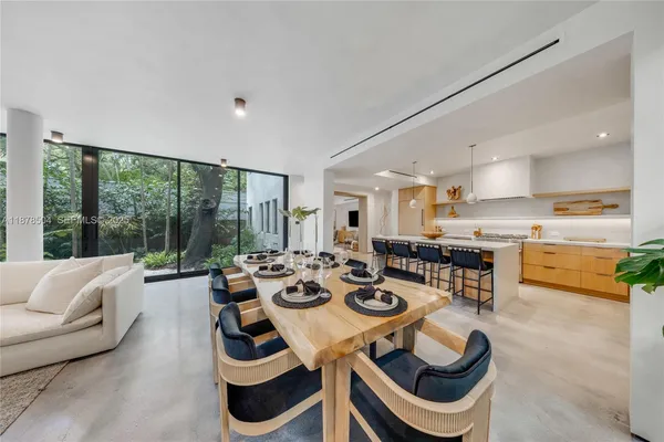 a view of a dining room and hall with furniture