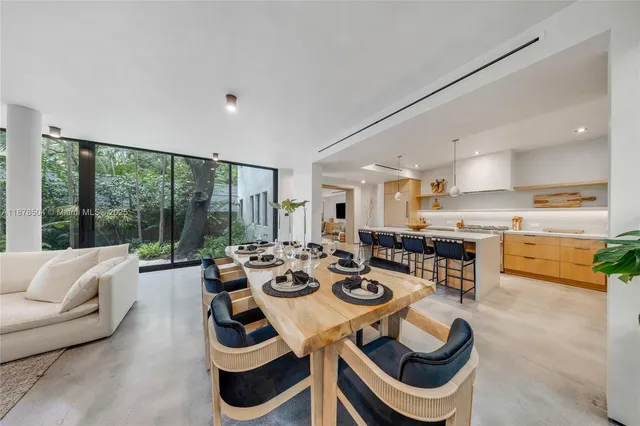 a view of a dining room and hall with furniture
