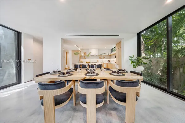 a kitchen with a sink and chairs