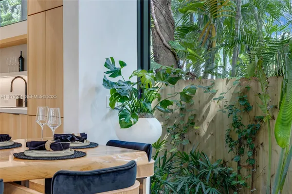 a table with chairs and a potted plant