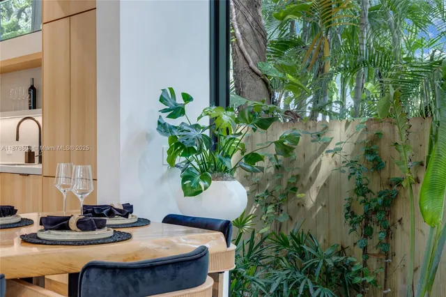 a table with chairs and a potted plant
