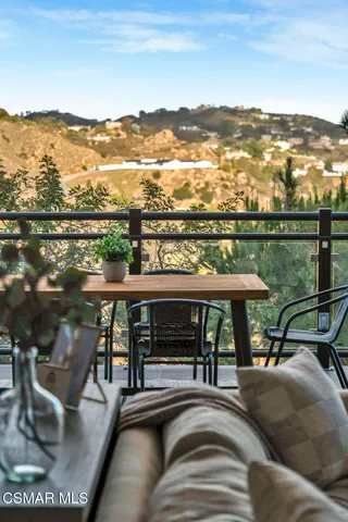 a view of a balcony with two chairs and a table