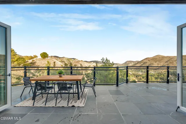 a view of a chairs and table on the terrace