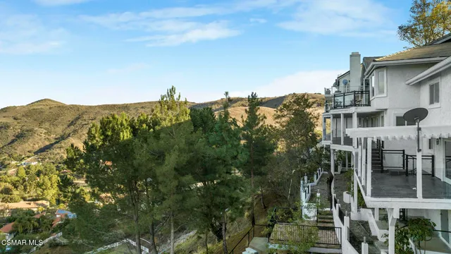 a front view of a house with a tree