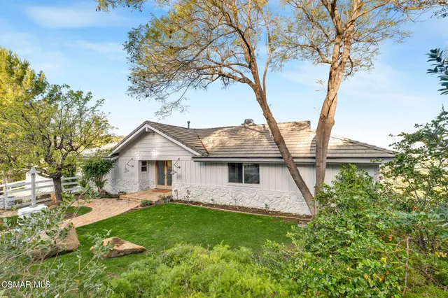 a bedroom with a bed mirror and a large window